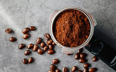 Ground coffee in portafilter filled ready for brewing espresso, Top view