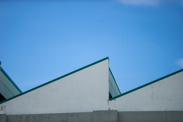 Geometric Roof Design Against Clear Blue Sky with Modern Aesthetics