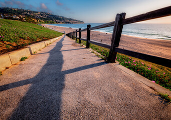 Redondo Beach walking ramp leading down to the beach on a beautiful day with blue sky, few...