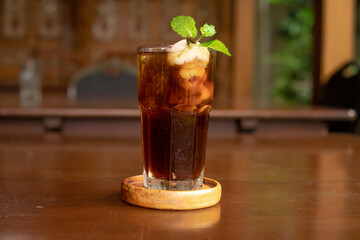 Leci Tea served elegantly with a slice of lemon on a wooden table, emphasizing presentation.