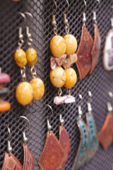 Unique handmade earrings displayed at a local market stand