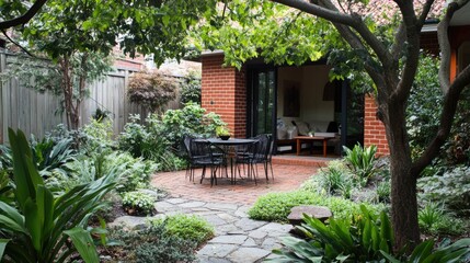 A backyard patio with seating under a leafy tree canopy.