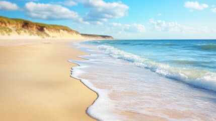 Obraz premium A serene beach scene showcasing a gentle wave rolling towards the shore, capturing the tranquility of nature's coastal beauty.