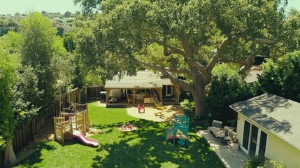 Fototapeta premium A backyard with a play area for kids under a large shady tree.