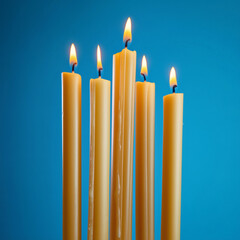 Burning Candles on a Blue Background