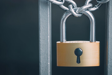 Secured padlock on metal gate, expressing security and protection