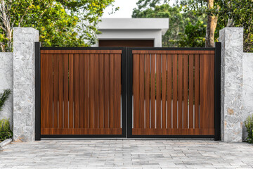 Wooden gate welcomes visitors to rural home, inviting them to enter peacefully