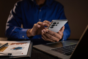 a businessman works overtime is his accounting firm's office until late at night, an entrepreneur remains at his export company because he has a lot of customer documents to check