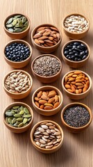 Obraz premium Assorted mineral-rich seeds in small bowls on dark wood table overhead shot soft diffused lighting healthy eating concept