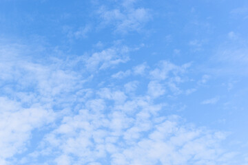 beautiful blue sky and white fluffy group of clouds with sunrise in the morning, natural background
