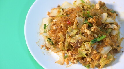 stir fried sukiyaki with egg and pork on white plate