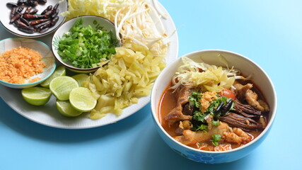 rice vermicelli with northern thai curry sauce on blue background