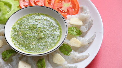 shrimp in fish sauce with Thai spicy seafood dipping sauce on white plate