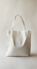 Empty white canvas tote bag against a plain background