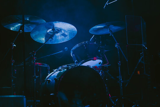 A Drum Kit on Stage waiting for a Concert to Start with a dark atmosphere and a spotlight
