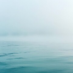 Body of water with a foggy sky in the background