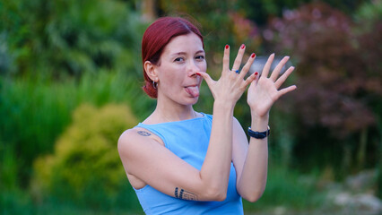 A young, beautiful businesswoman sticking her tongue out and having fun while looking at the camera...