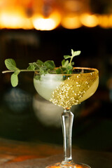 Golden Garnish: Elegant Cocktail with Herb Accent