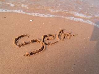 Writing the sand a personal message the beach coastal environment close-up view