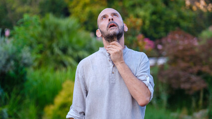 A handsome middle-aged businessman looks at the camera with a facial expression that clearly shows...