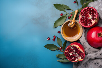 Fresh pomegranate halves display vibrant seeds beside jar of honey and green leaves on soft cloth, creating colorful and appetizing arrangement.