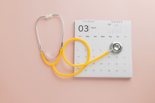 Doctor Day design with calendar and yellow stethoscope on pink. A theme promoting annual checkups