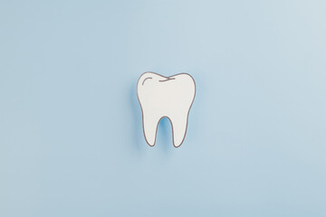Dentist Day, a tooth paper cut shape represents dental health on blue