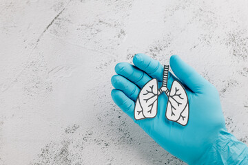 World TB Day concept features lungs paper in gloved doctor hands. Emphasizing awareness
