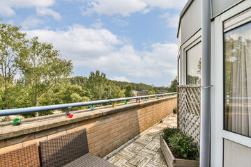 A charming balcony scene featuring a mix of greenery and a clear sky, providing a perfect outdoor escape. Ideal for relaxation and enjoying nature's beauty.
