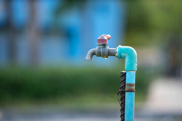 Close-Up of a Outdoor Faucet with Dripping Water on a Sunny Day