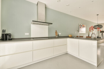 Bright and airy modern kitchen featuring sleek white cabinetry, a minimalist aesthetic, and stylish decor elements, creating a warm and inviting atmosphere.