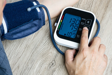 Man check blood pressure monitor and heart rate monitor with digital pressure gauge. Health care...