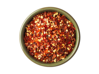 Close up spicy chili red pepper flakes, chopped, milled dry paprika pile in bowl isolated on white, top view
