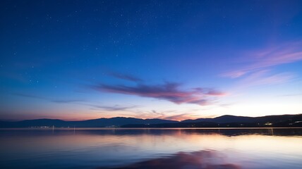 Fototapeta premium Twilight Serenity: A tranquil twilight scene with a lake mirroring the stunning colors of the evening sky, where shades of blue and pink blend beautifully, creating a serene and mesmerizing view.