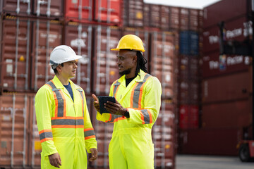 Caucasian and African American engineer man use tablet computer working at container site