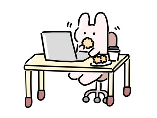 パソコン作業をしながらおかしを食べるうさぎ