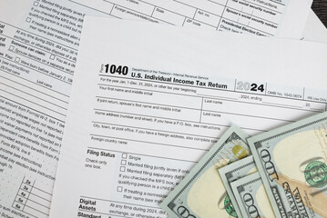 Obraz premium Tax form 1040 on dark wooden background, financial document.