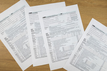 Fototapeta premium Tax form 1040 on wooden office desk, financial document.