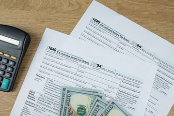Obraz premium Tax form 1040 on wooden office desk, financial document.