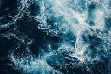 Stunning top down view of ocean waves in dark blue and white, captured in hyper realistic style