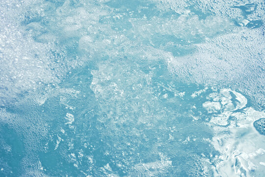 Surface of bubbling water in home hot tub without people.