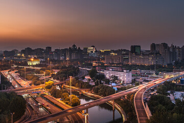 Obraz premium The busy traffic scene of urban overpasses in Beijing, China under the twilight