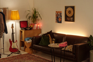 Cozy living room featuring a guitar, retro decorations, and a warm lighting scheme Creating...