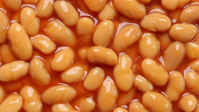 Baked beans in tomato sauce rotating. Top view 