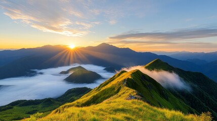 Breathtaking Sunrise Over Mountain Peaks with Misty Valleys and Vibrant Green Grass in a Serene Natural Landscape