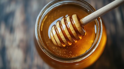 Golden honey in glass jar with wooden dipper on rustic table top view sweet treat breakfast ingredient natural light healthy food concept