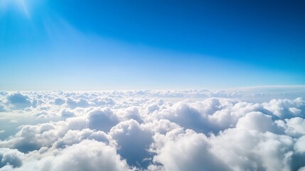 Fototapeta premium Expansive aerial view of fluffy clouds floating against a bright blue sky filled with sunlight : Generative AI
