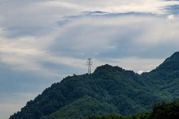 Obraz premium electricity pylon on the mountain on a cloudy day