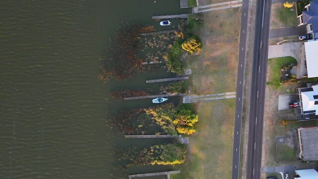 Aerial view of few jetties with boats along the Murray River shoreline in Goolwa, South Australia