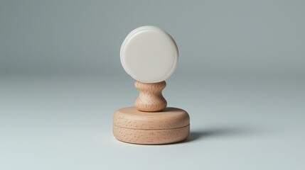 A wooden and white stamp tool is displayed on a surface
